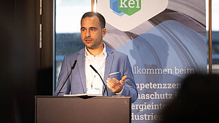 Ein Mann spricht an einem Rednerpult mit Blick in das Publikum
